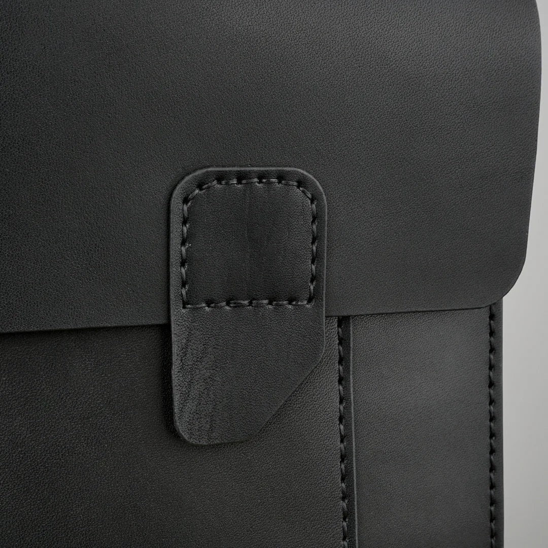 MODISTIAZ black leather document folio with snap closure and stitched detailing.