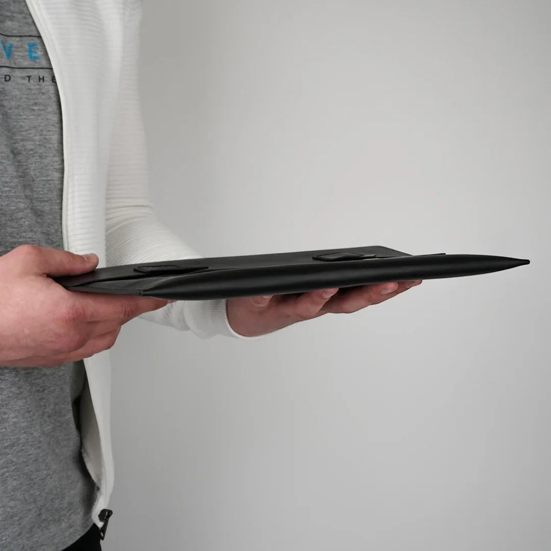 MODISTIAZ black leather document folio with snap closure and exterior pocket, held by a person.