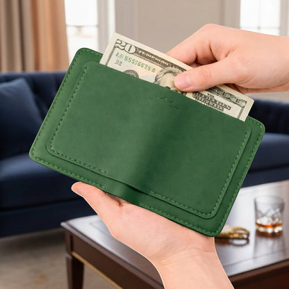 MODISTIAZ green faux leather slim travel wallet with passport holder and card slots, holding cash.
